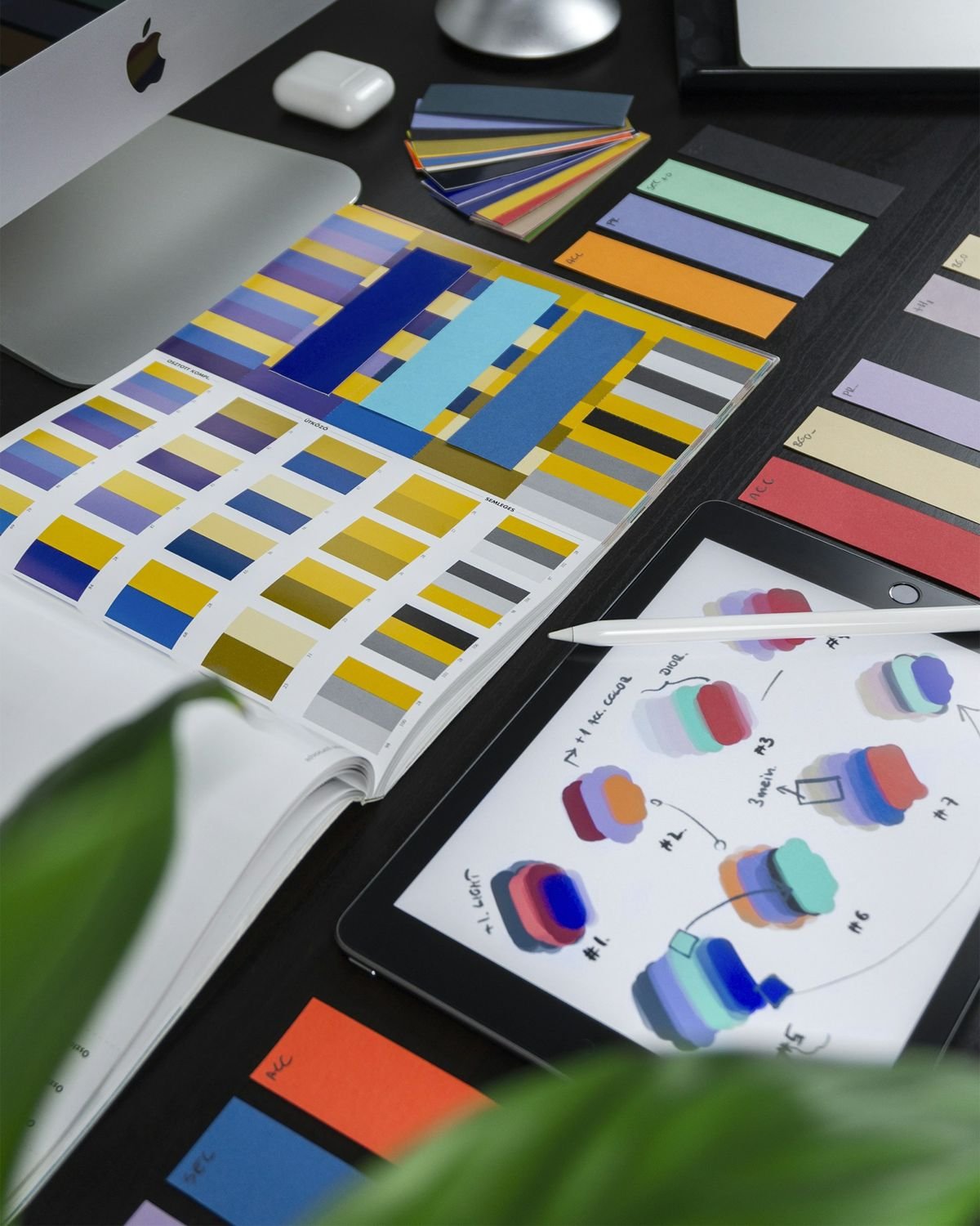 Color swatches and brand design materials on a desk