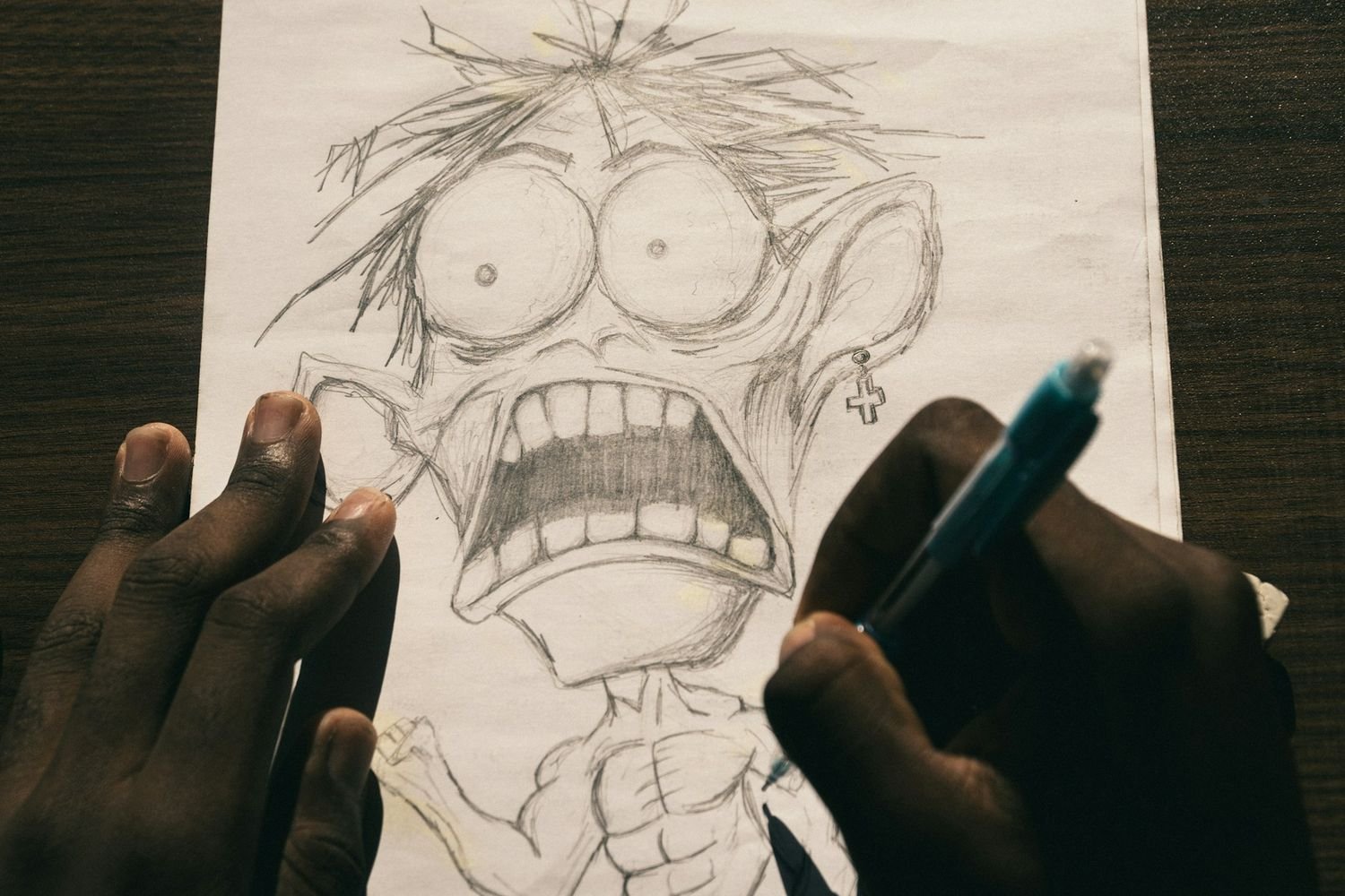 Artist drawing a comic character sketch by hand