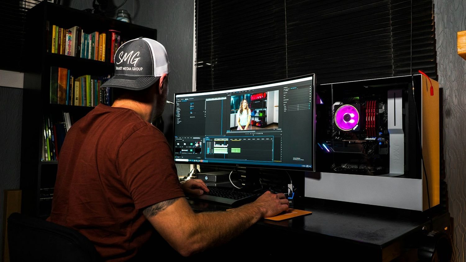 Editor color grading footage at a multi-monitor workstation