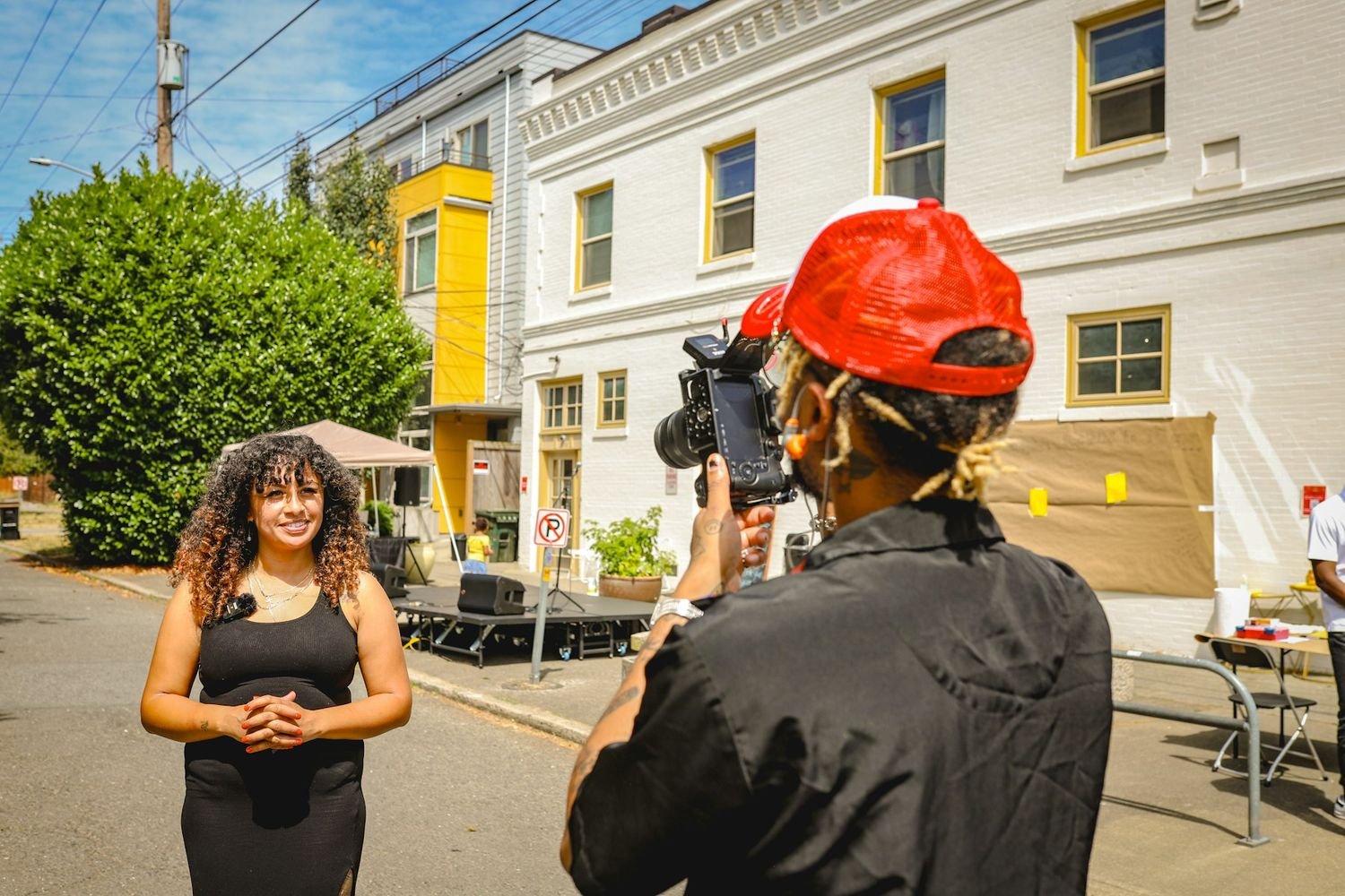 Filmmaker recording an on-camera interview on a city street
