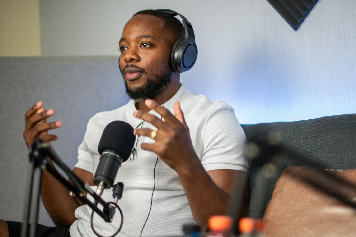 Podcast host speaking into a studio microphone